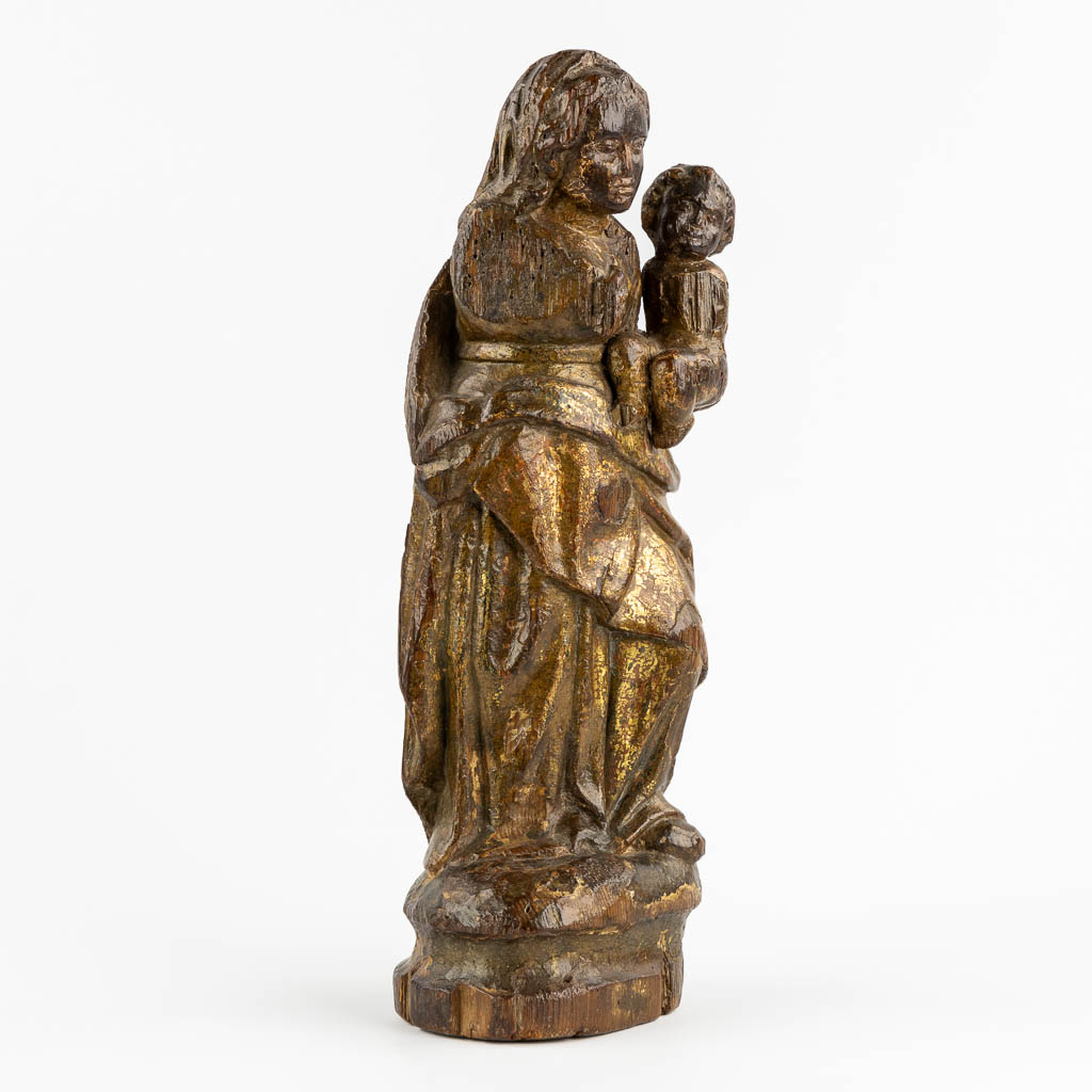 An antique wood-sculptured figurine of Madonna with a Child. 17th/18th C. (L:12 x W:16 x H:46 cm)