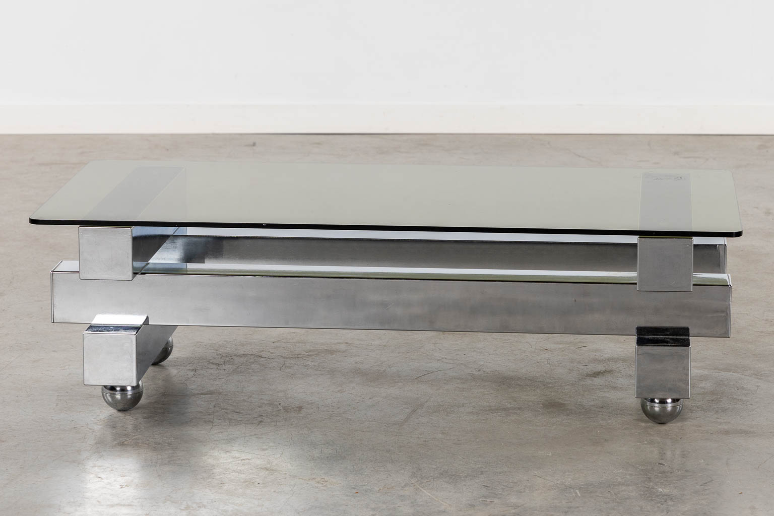 A coffee table, chromed steel and glass. (L:52 x W:104 x H:31 cm)