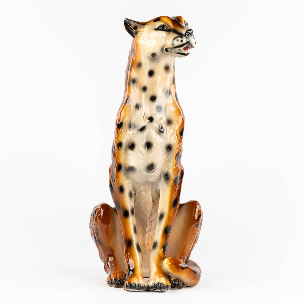 A decorative figurine of a leopard, patinated resine. 