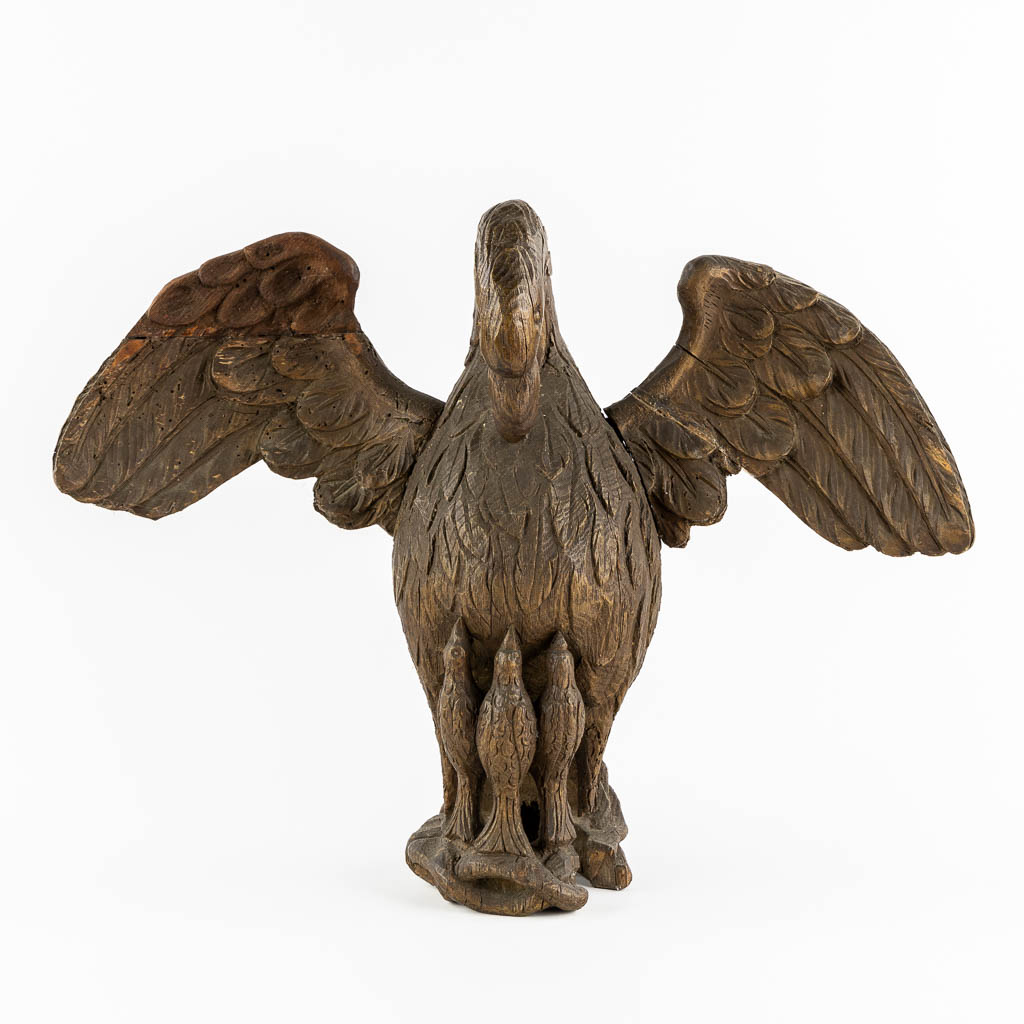 An antique wood-sculptured 'Pelican With Chicks'. 18th/19th C.