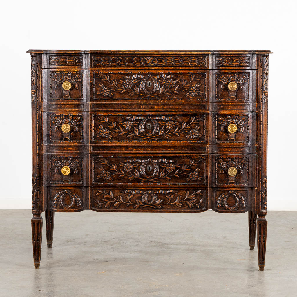 A three-drawer commode, floral wood-sculptures in a Louis XVI style. (L:60 x W:110 x H:99 cm)