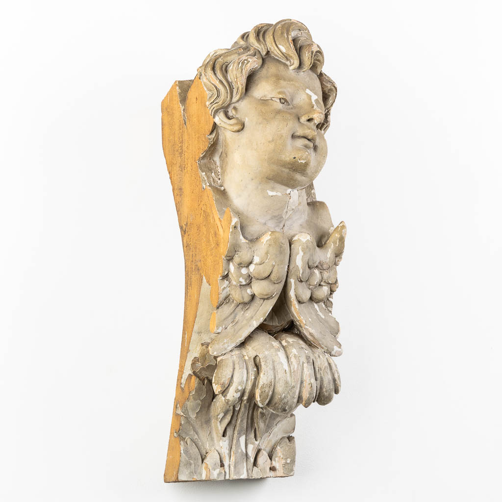 A baroque figurine of an angel, wood-sculptured and patinated, 18th C. (L:20 x W:20 x H:65 cm)