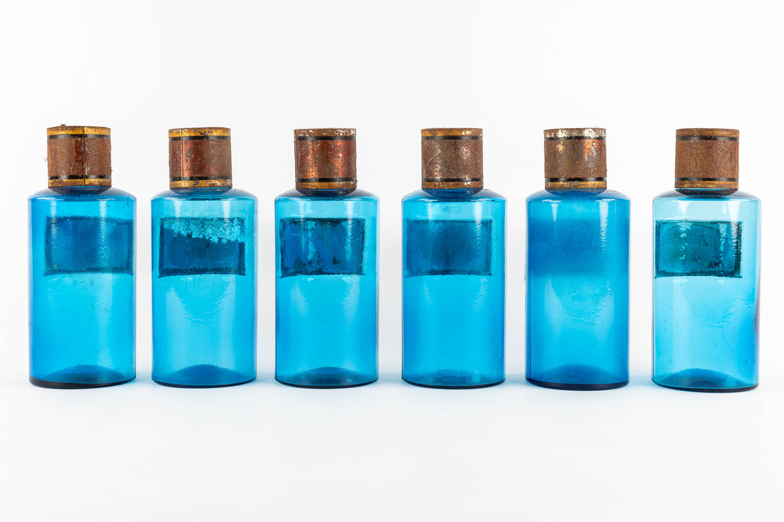 Six blue glass Pharmacy bottles with enamel plaques, circa 1880-1900. (H:23,5 x D:9,5 cm)