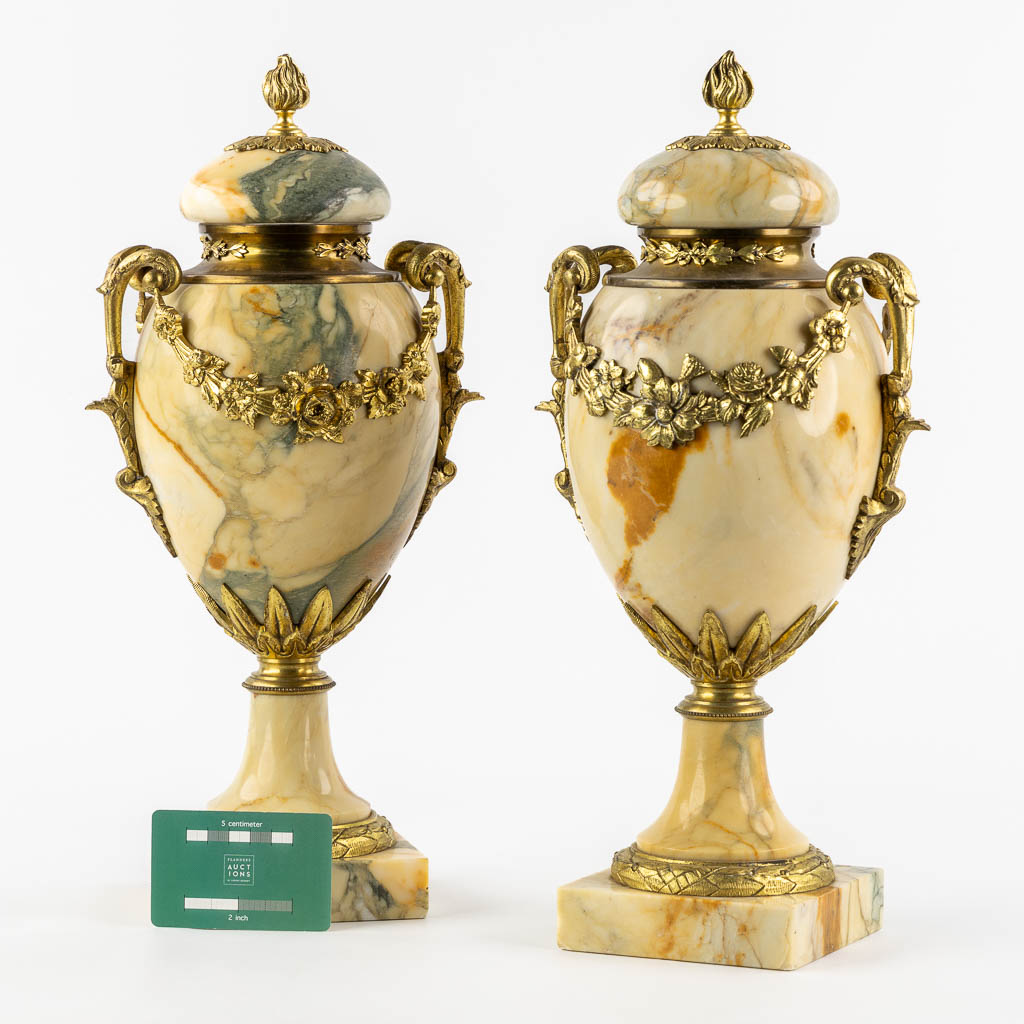 A pair of marble and bronze cassolettes with a garland decor. Circa 1900. (L:16 x W:20 x H:41 cm)