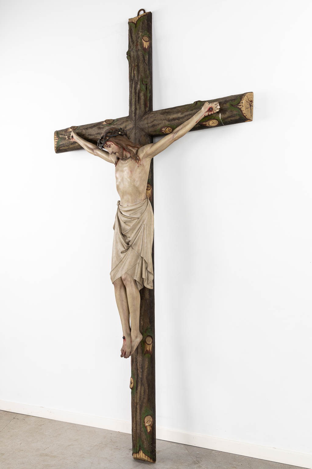 A large Corpus Christi, mounted on a faux tree crucifix, polychrome plaster. (W:130 x H:250 cm)