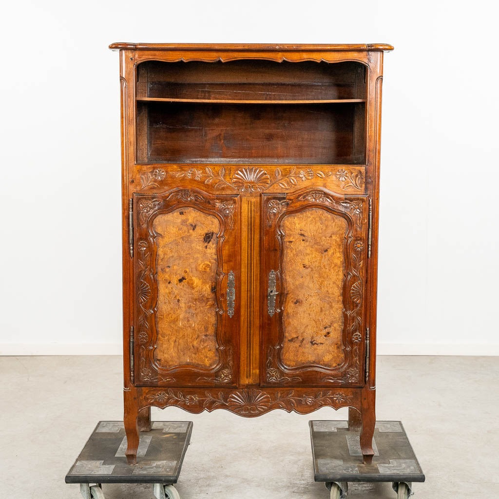 A two door-cabinet, sculptured wood finished with root-wood veneer. 