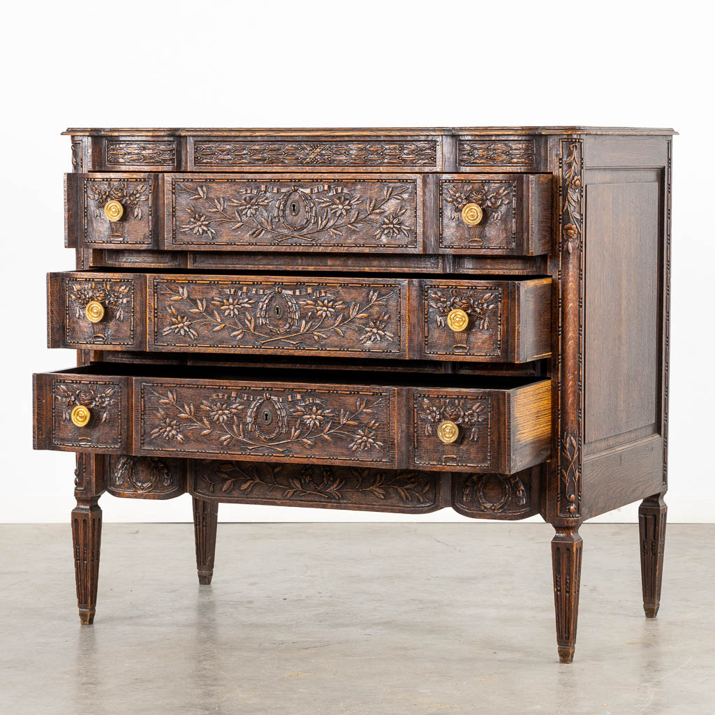 A three-drawer commode, floral wood-sculptures in a Louis XVI style. (L:60 x W:110 x H:99 cm)