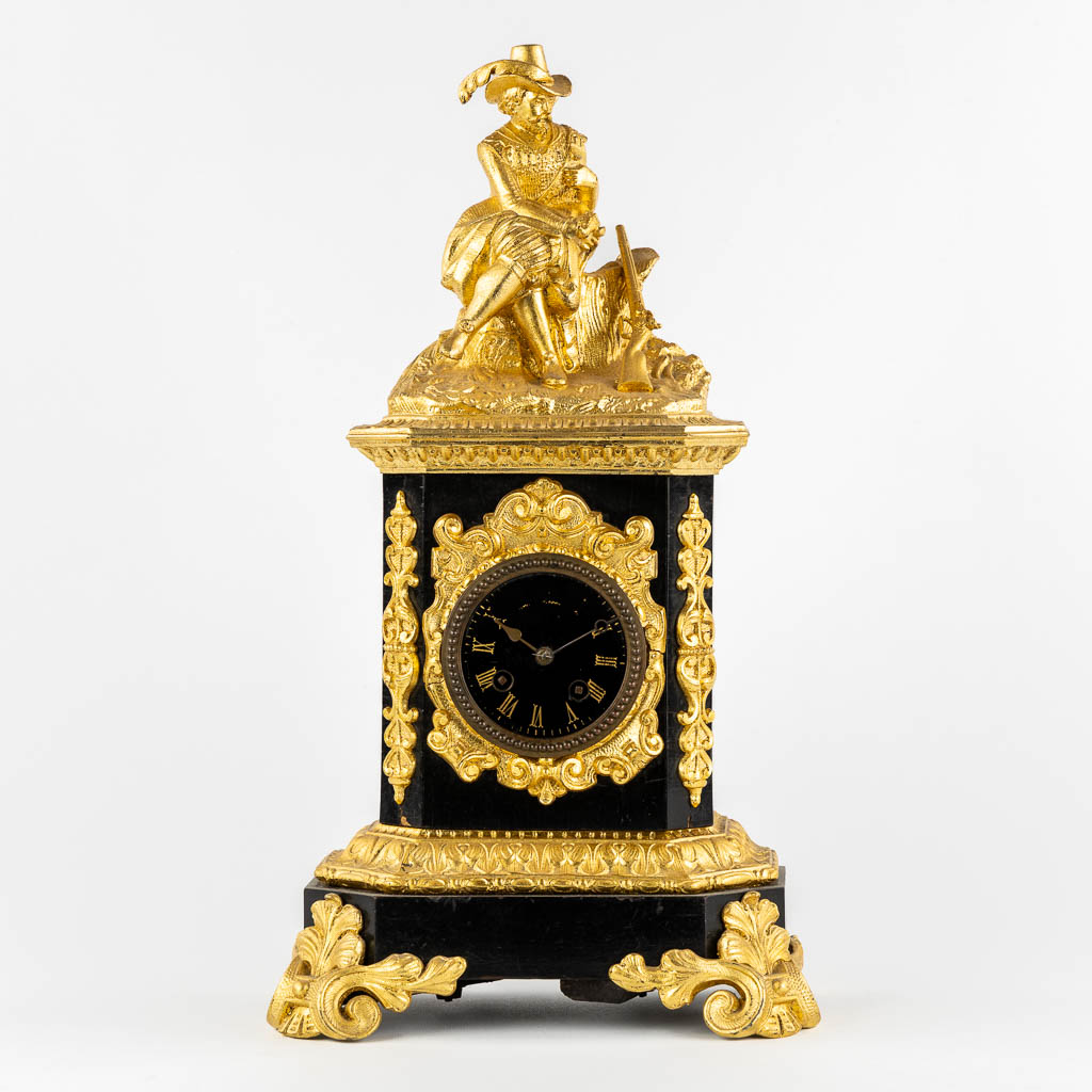 A mantle clock with a 'Hunter', gilt spelter mounted on ebonised wood. 19th C.