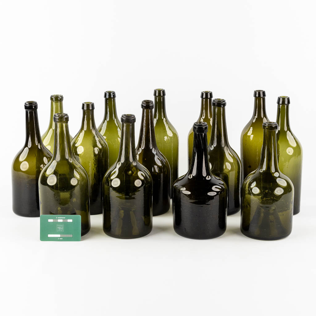 Fourteen antique glass bottles. Olive green glass. 18th and 19th C.