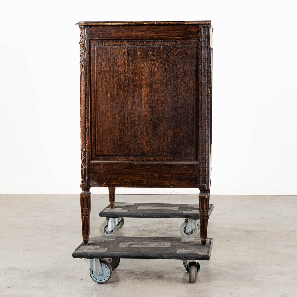 A three-drawer commode, floral wood-sculptures in a Louis XVI style. (L:60 x W:110 x H:99 cm)