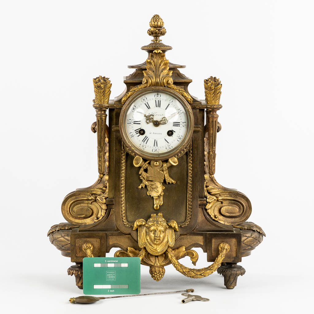 A mantle clock, gilt bronze in a Louis XVI style. Circa 1900. (L:16 x W:32 x H:41 cm)