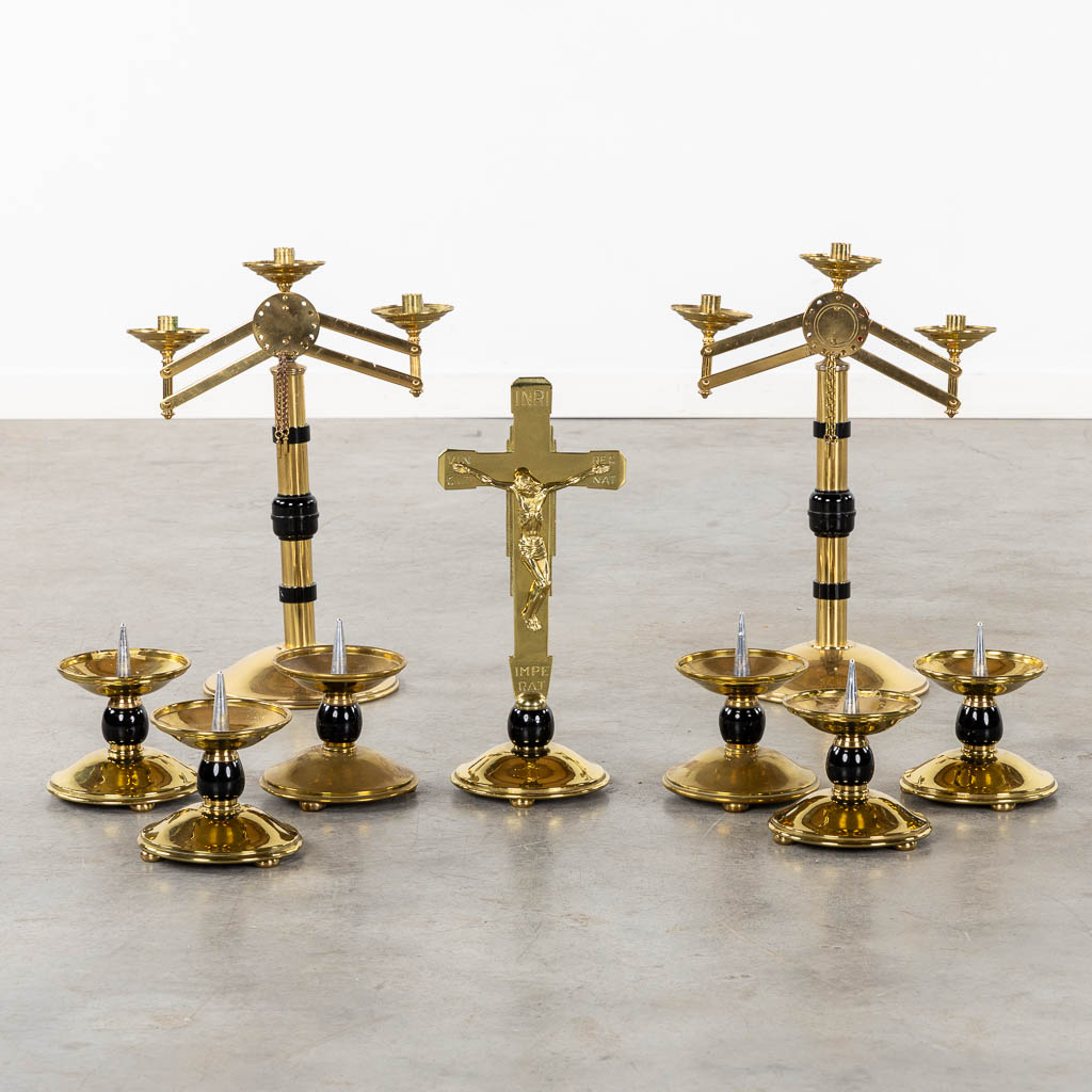 An altar crucifix with 6 candelabra, added are two large with moveable arms. (W:37 x H:51 cm)