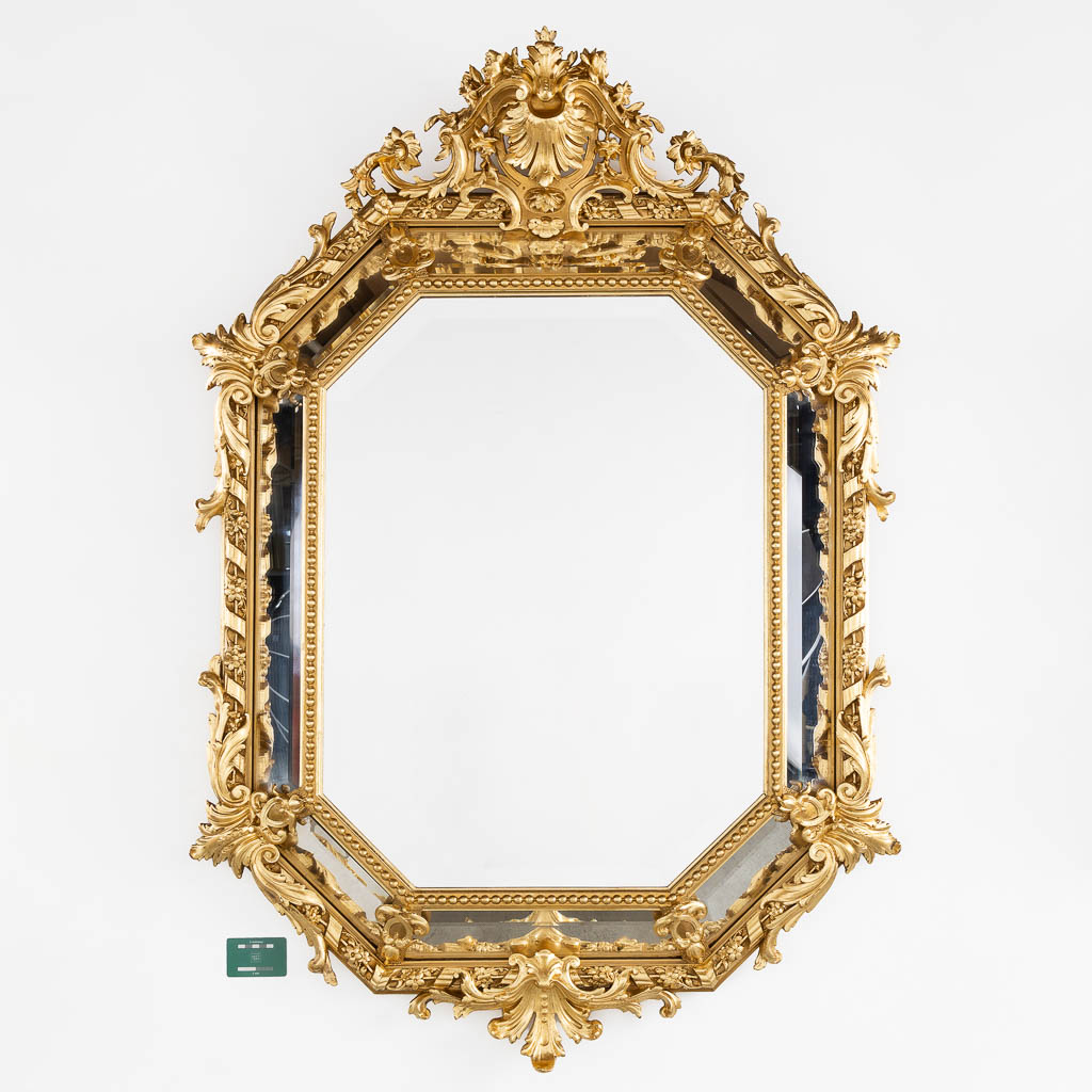 An antique mirror, sculptured gilt stucco and facetted glass, Louis XV style. 19th C. (W:98 x H:140 cm)