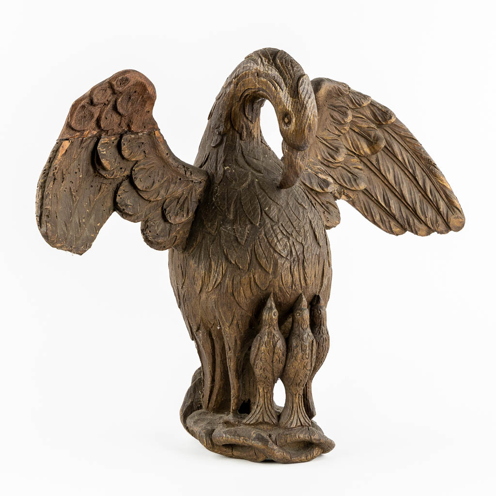 An antique wood-sculptured 'Pelican With Chicks'. 18th/19th C.