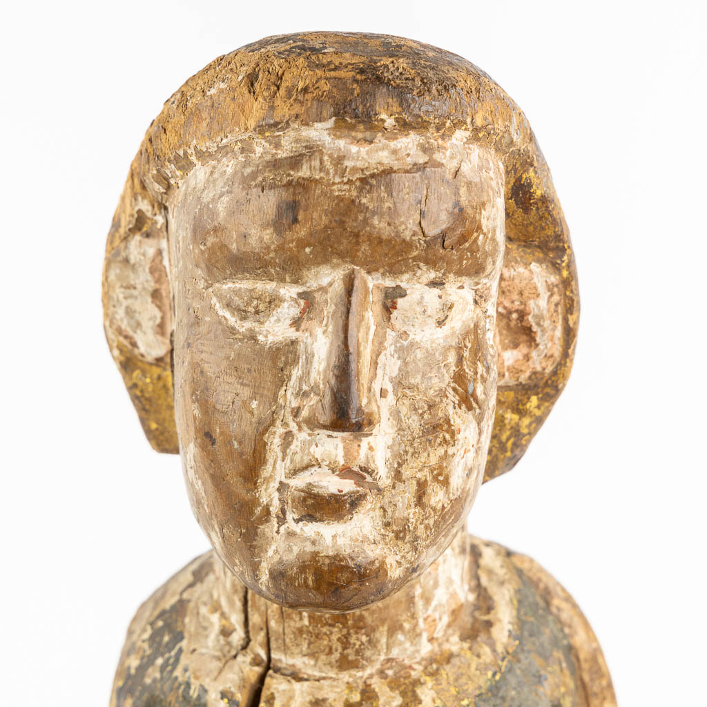 An antique wood sculpture of a Deacon, Roman period, possibly Catalonia. 12th C. (L:14 x W:15 x H:57 cm)