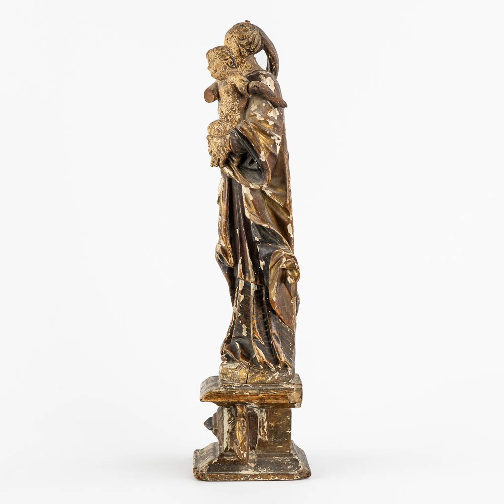 An antique wood-sculptured figurine of Madonna with a Child. 17th/18th C. (L:11,5 x W:16 x H:45 cm)