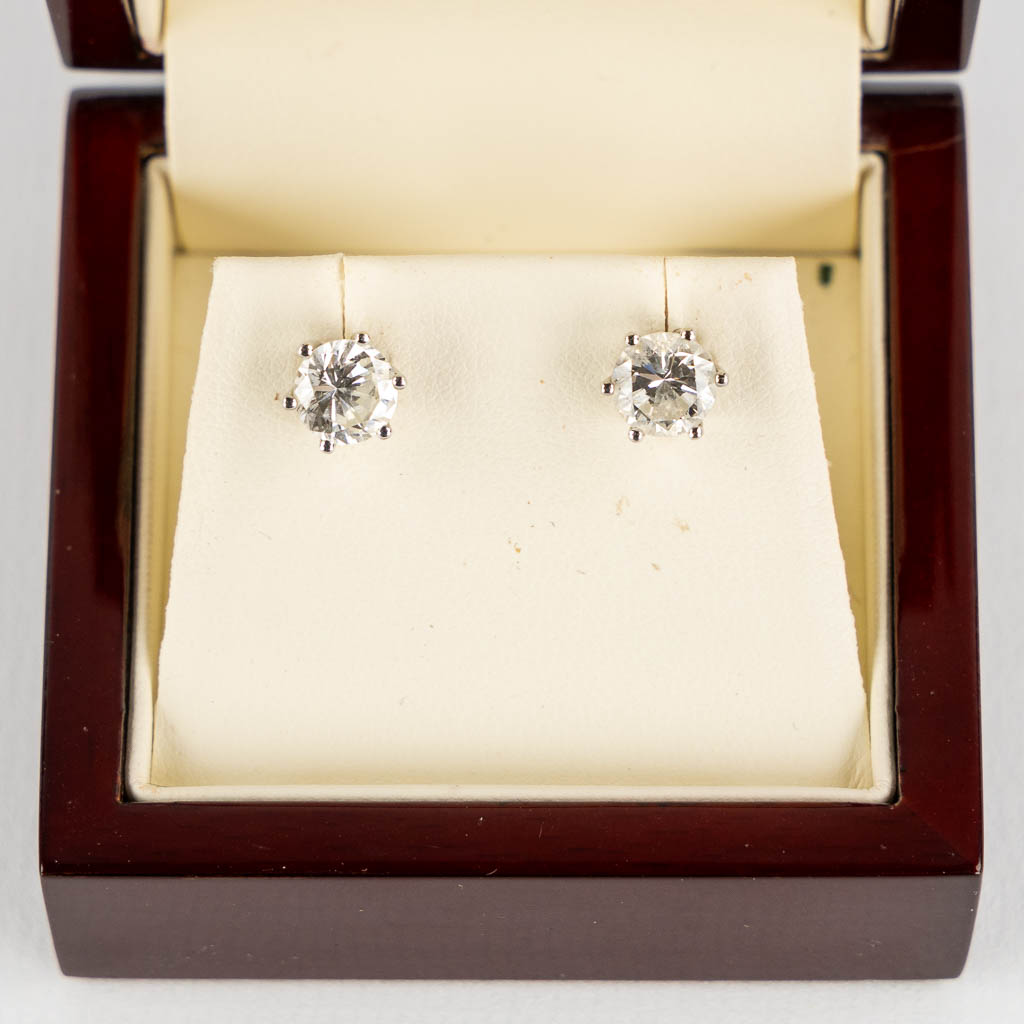 A pair of earrings each with diamond of approximately 1ct. 18kt white gold. 