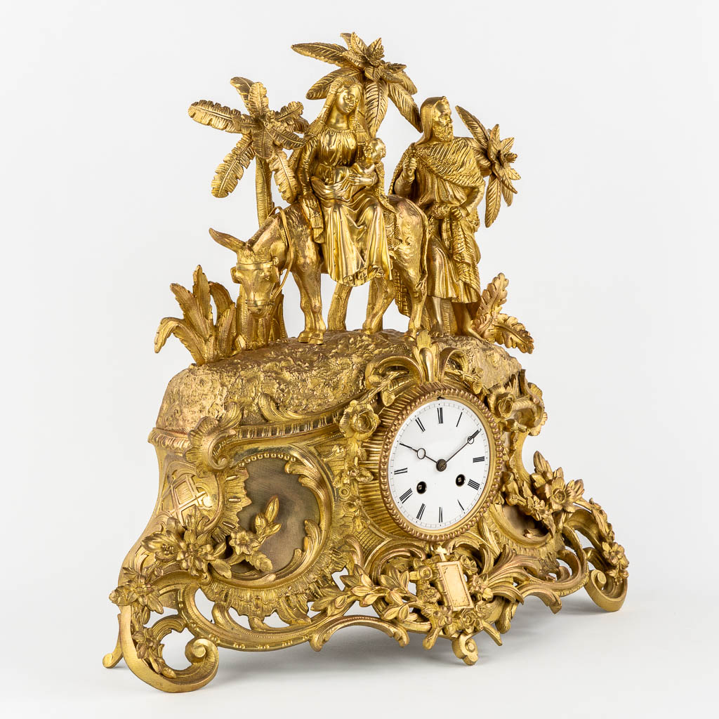 A mantle clock gilt bronze 'The Flight into Egypt'. 19th C.