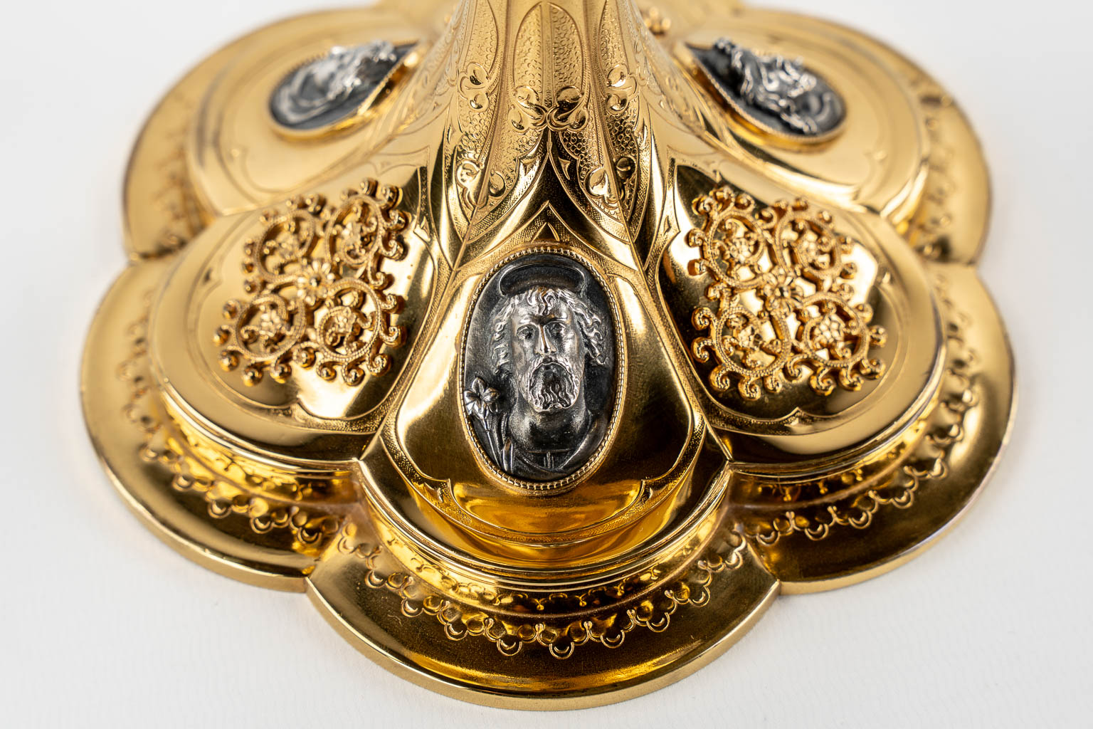 A Gothic Revival chalice with enamel plaques, cabochons. Silver Cuppa, Gilt brass, 19th C.