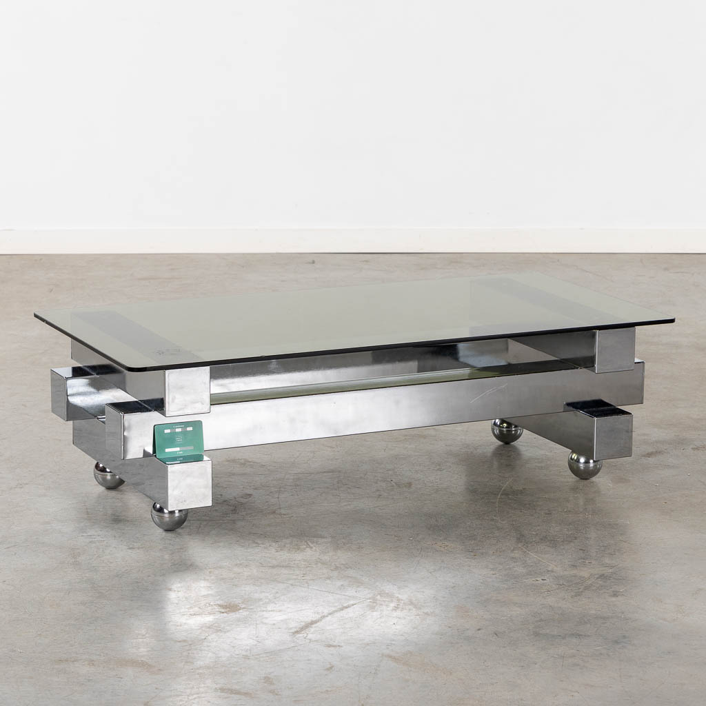 A coffee table, chromed steel and glass. (L:52 x W:104 x H:31 cm)