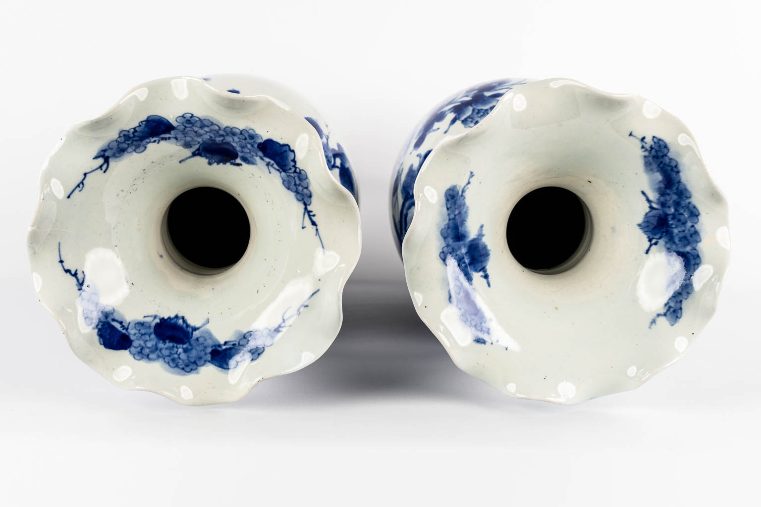 A pair of Japanese vases, Blue-white with a floral decor. 