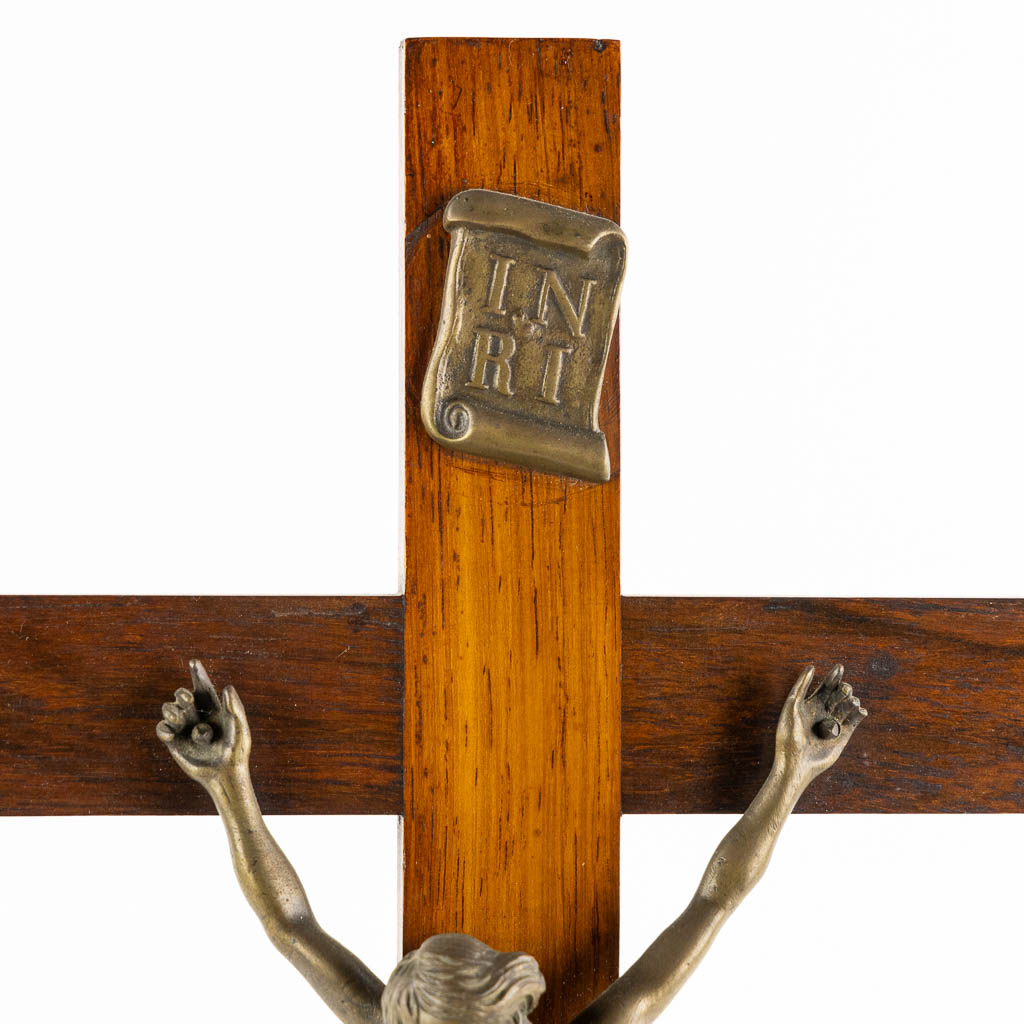 A bronze Corpus Christi mounted on a mahogany and marquetry inlay crucifix.