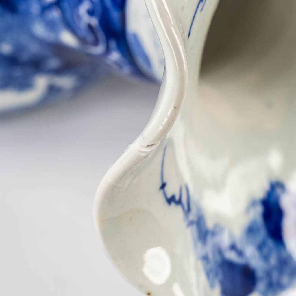 A pair of Japanese vases, Blue-white with a floral decor. 