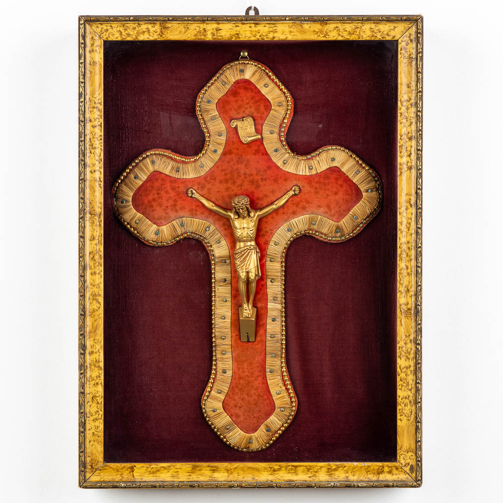 A framed embroidered crucifix with a Corpus Christi, framed behind glass. 