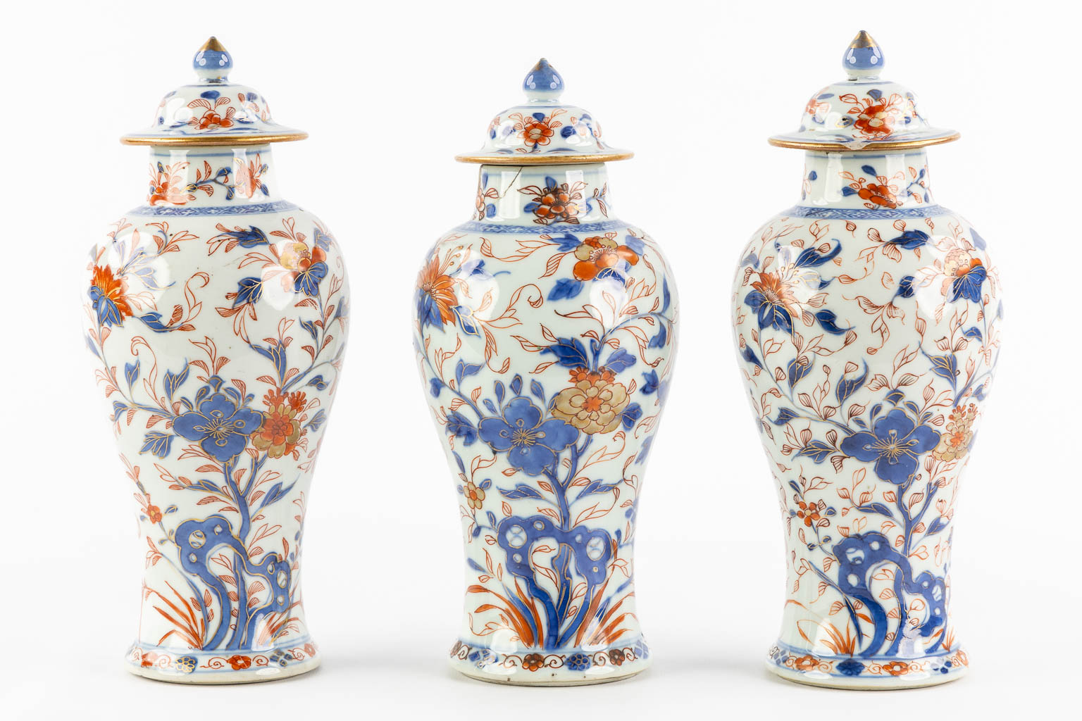 Drie Chinese Imari stijl vazen met een deksel en floraal decor, Kangxi. (H:27 x D:11 cm)