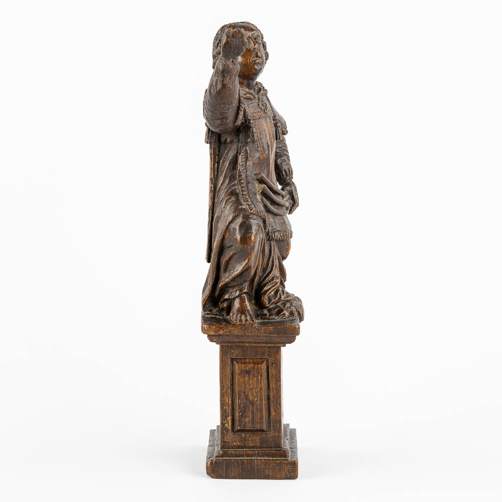 An antique wood-sculptured figurine of a saint holding a scourge. 17th C. (W:10 x H:29 cm)