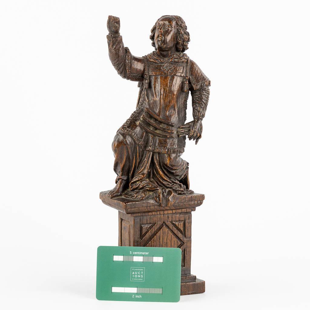 An antique wood-sculptured figurine of a saint holding a scourge. 17th C. (W:10 x H:29 cm)