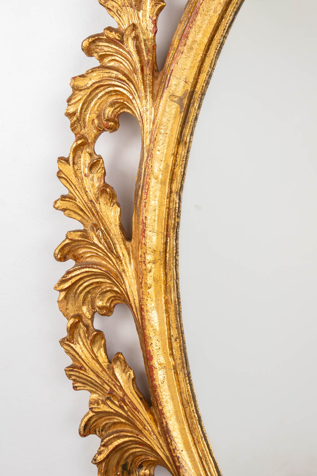 A wood-sculptured oval mirror, circa 1960. (W:73 x H:94 cm)