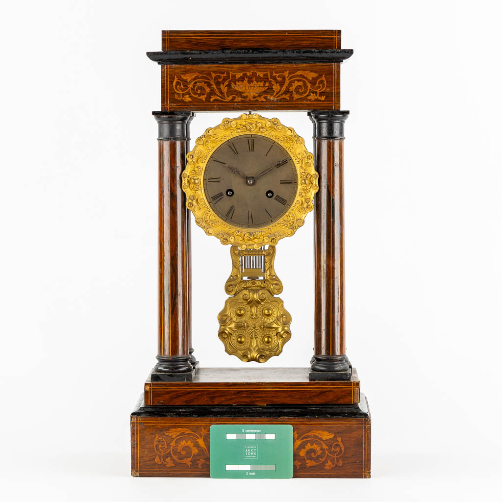 A column clock, marquetry inlay and gilt bronze. 19th C. (L:15 x W:25 x H:46 cm)