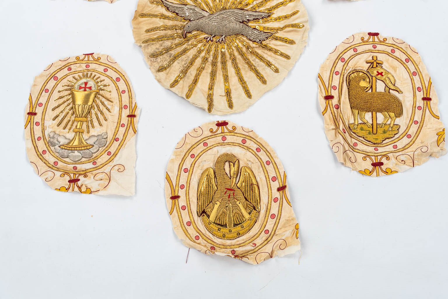 Seven thick-gold thread embroideries for Chasubles and Copes. IHS, Dove, Holy Grail and Lamb of God.