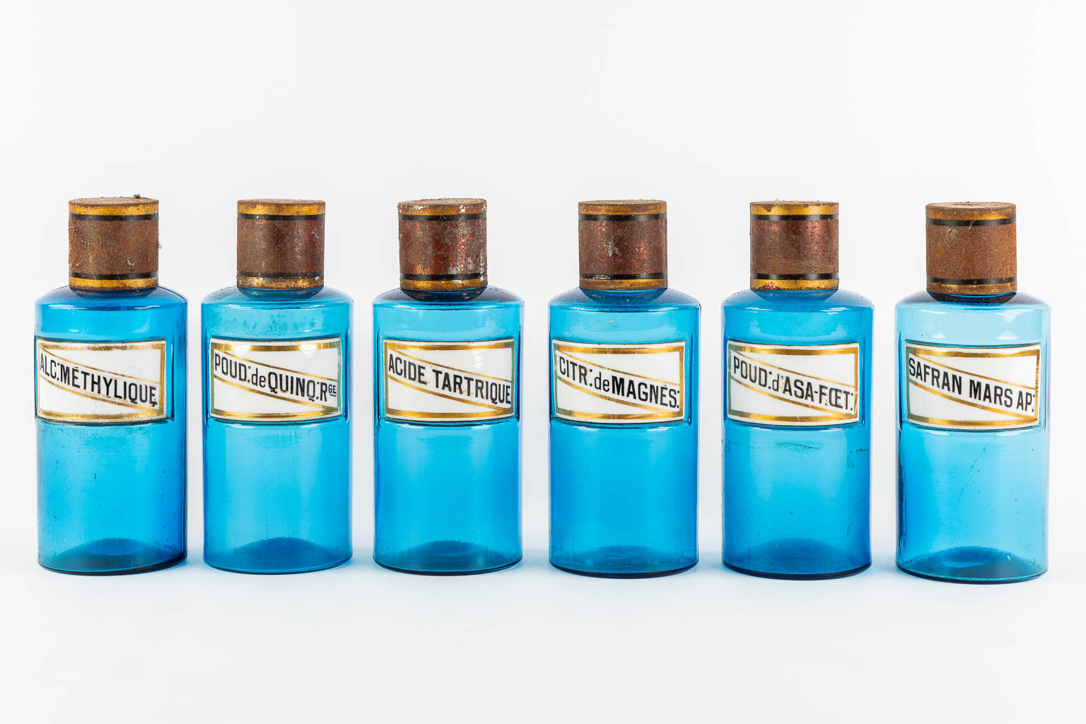 Six blue glass Pharmacy bottles with enamel plaques, circa 1880-1900. (H:23,5 x D:9,5 cm)