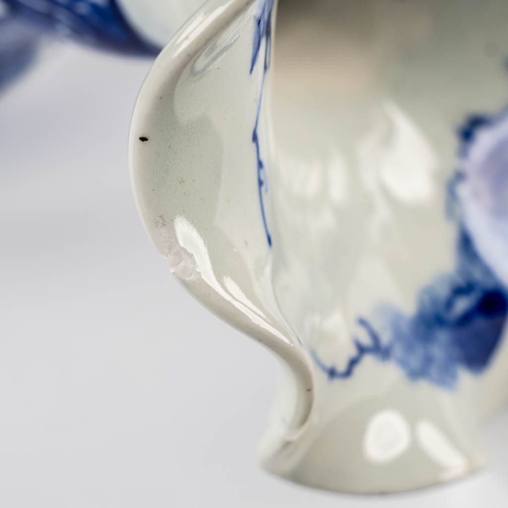 A pair of Japanese vases, Blue-white with a floral decor. 