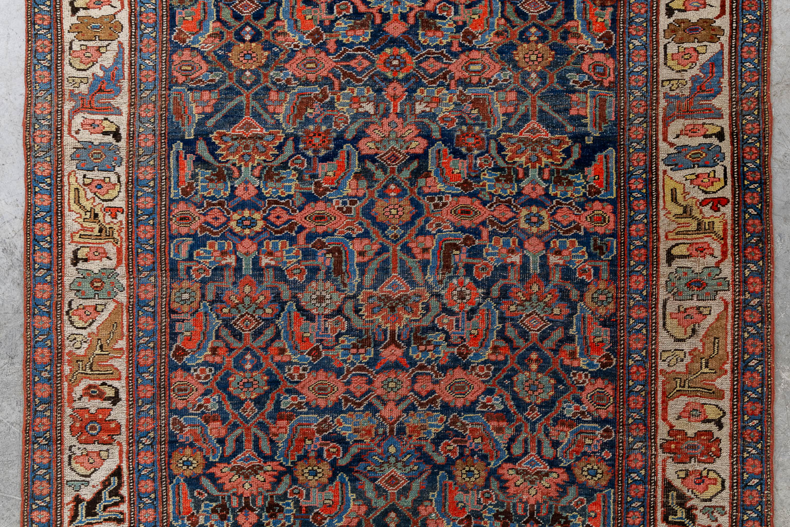 A Persian hand-made runner with floral decor. (L:120 x W:319 cm)