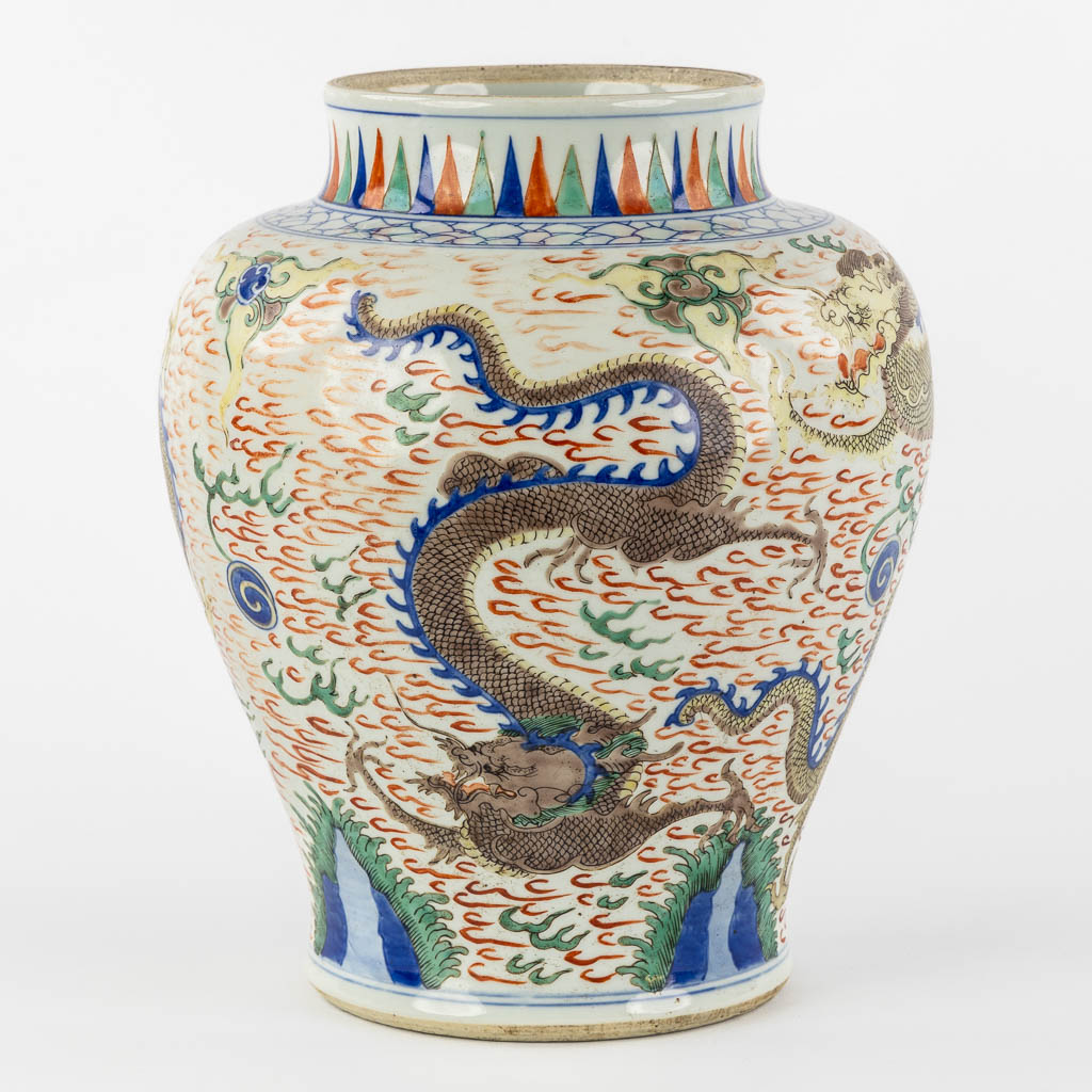 A Chinese Wucai vase with a dragon decor, 19th C.