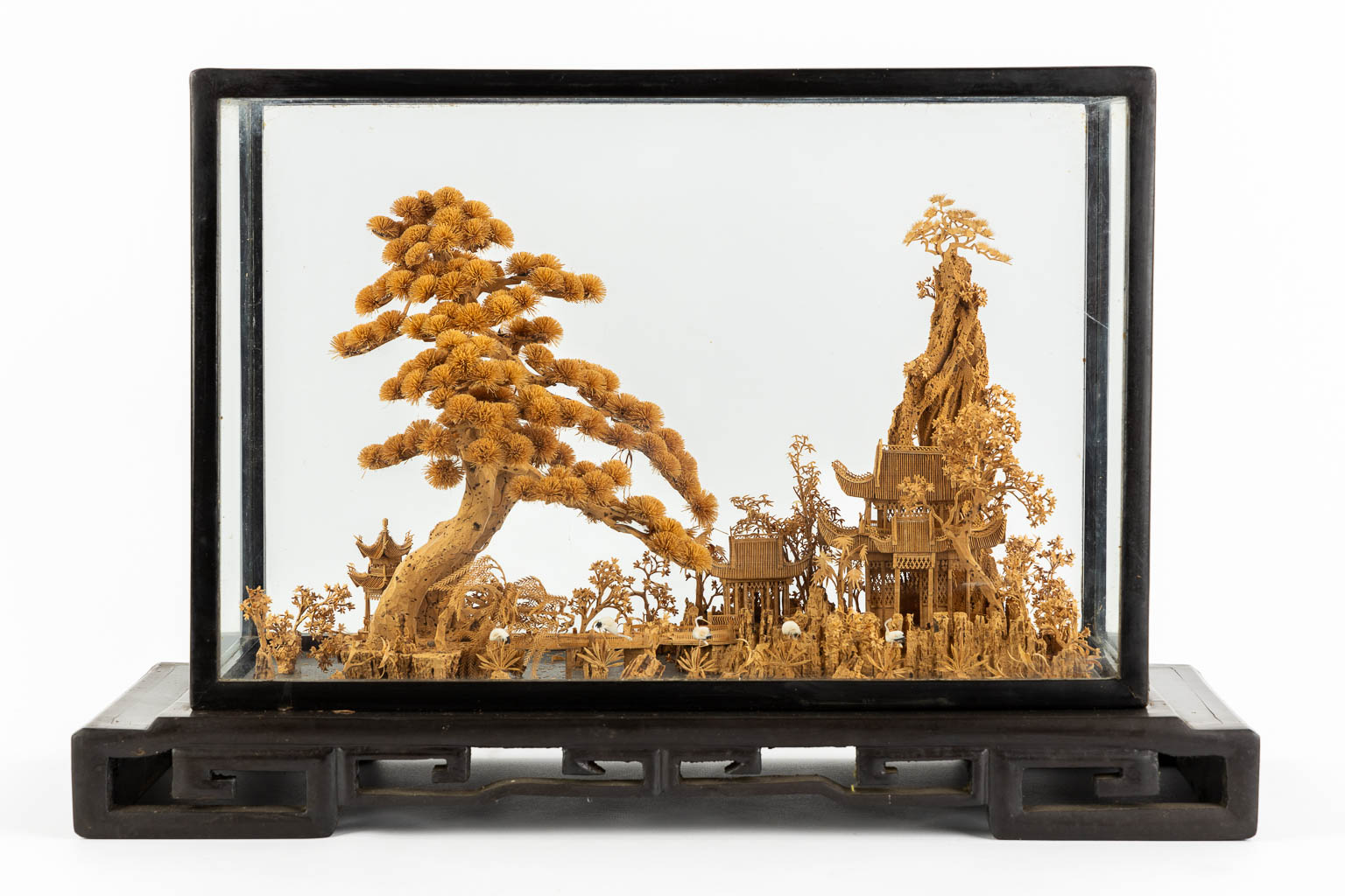 A Japanese cork diorama of a garden, in a glass display cabinet. 20th C. (L:25 x W:55 x H:36 cm)