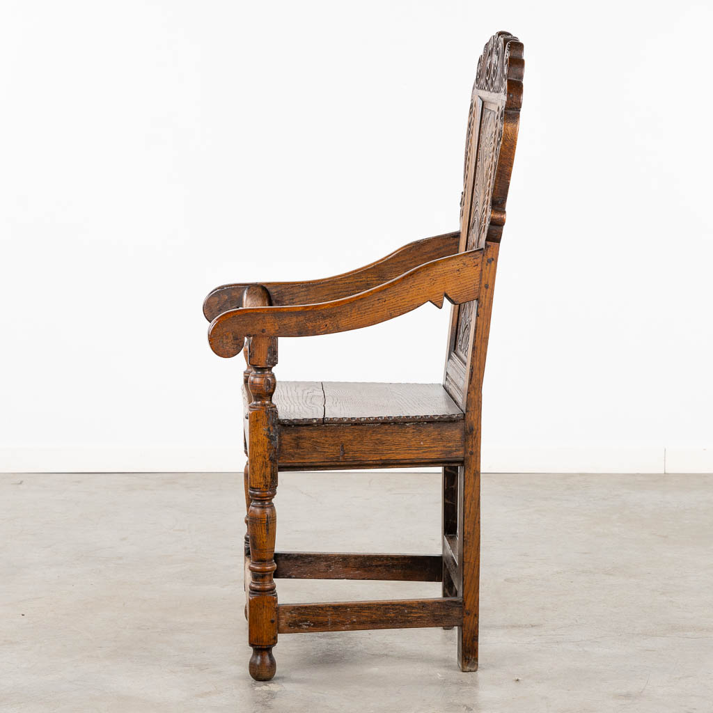 A wood-sculptured armchair, Flanders, 18th C. (L:55 x W:55 x H:117 cm)