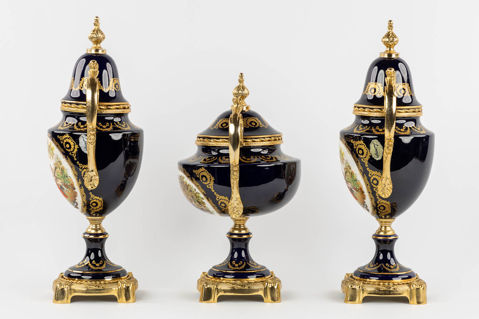 Limoges, a three-piece mantel garniture, porcelain mounted with bronze. 20th C.