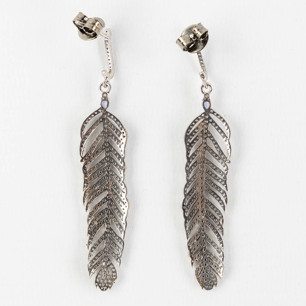 A pair of feather shaped earrings, silver with old-cut diamonds and Tanzanite cabochons. (H:7,5 cm)