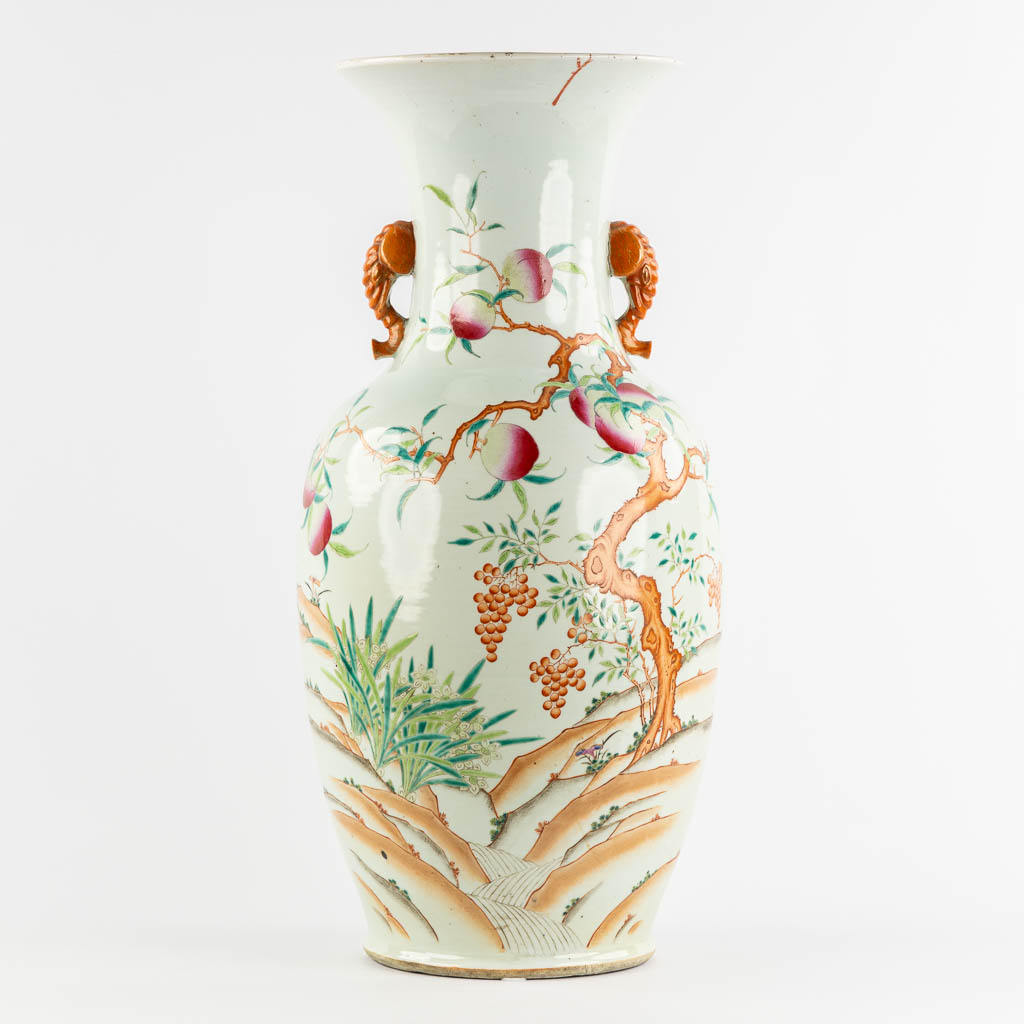 A large Chinese Famille Rose vase with a peach decor and elephant handles. 19th C. (H:70 x D:34 cm)