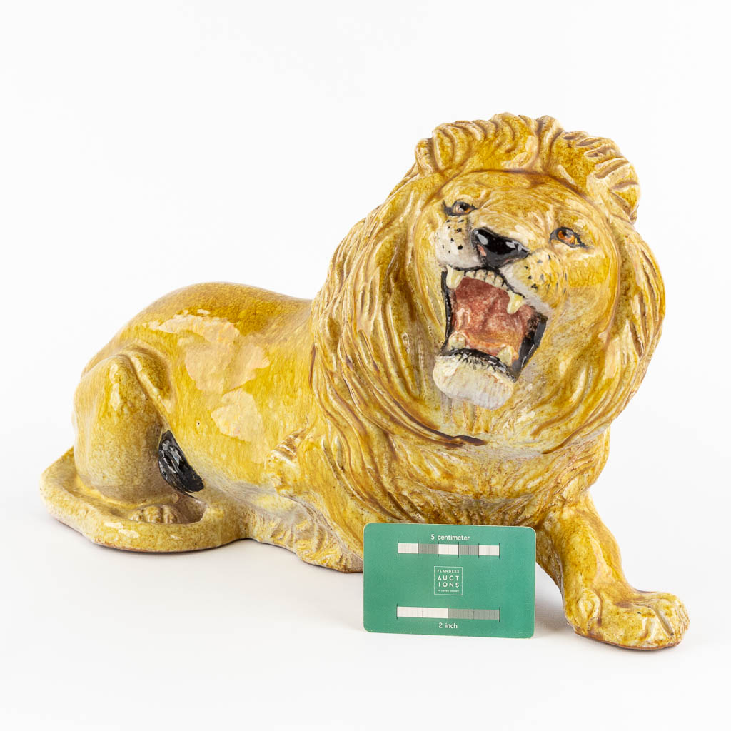 A decorative lying lion, glazed terracotta. Italy, circa 1960-1970. 