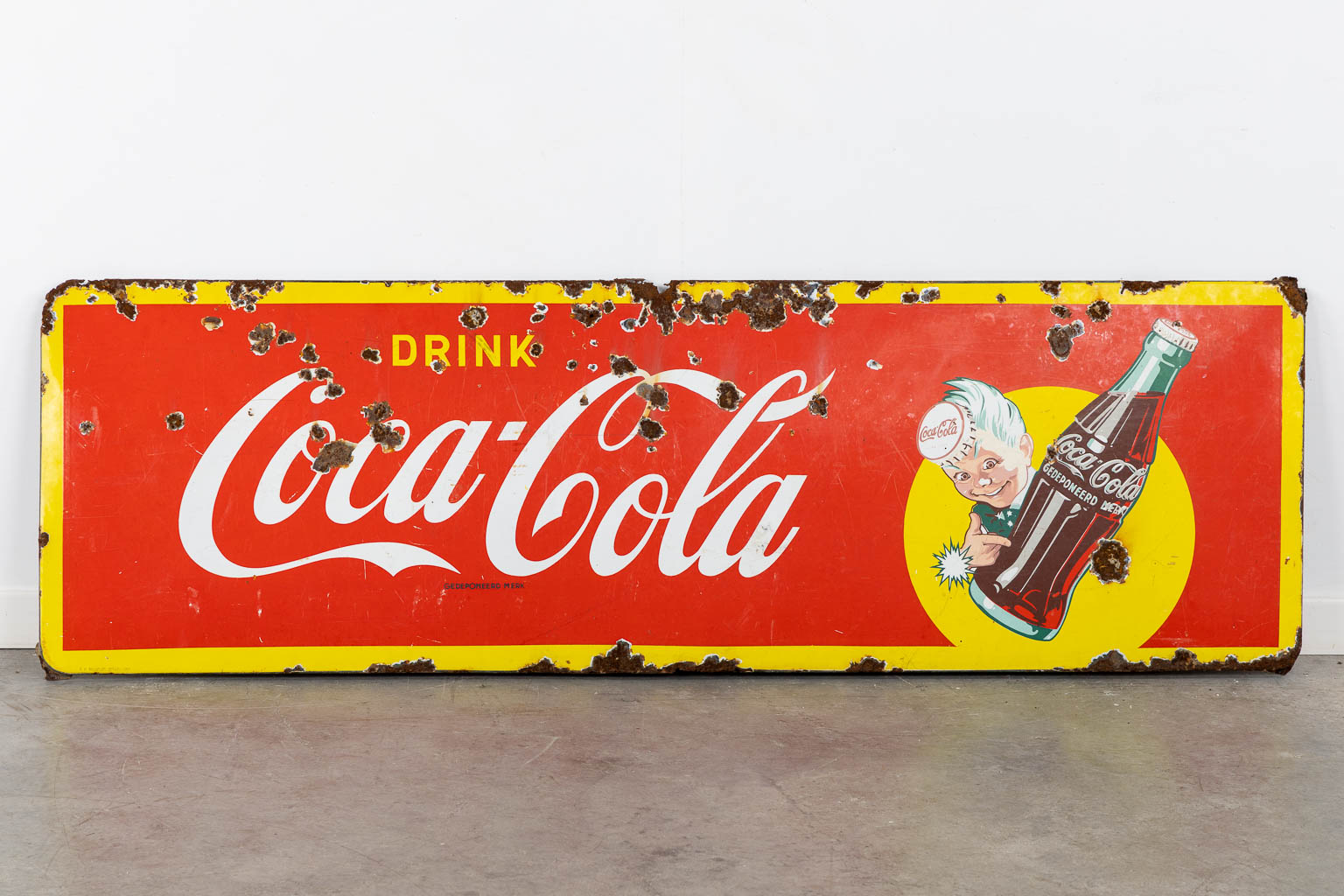 "Drink Coca Cola", a large enamel advertising board, 1957. (W:145 x H:46 cm)