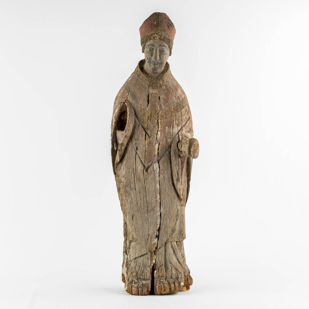 An antique wood-sculptured figurine of a Bishop, Roman, mid-13th/early 14th C. (L:23 x W:27 x H:88 cm)