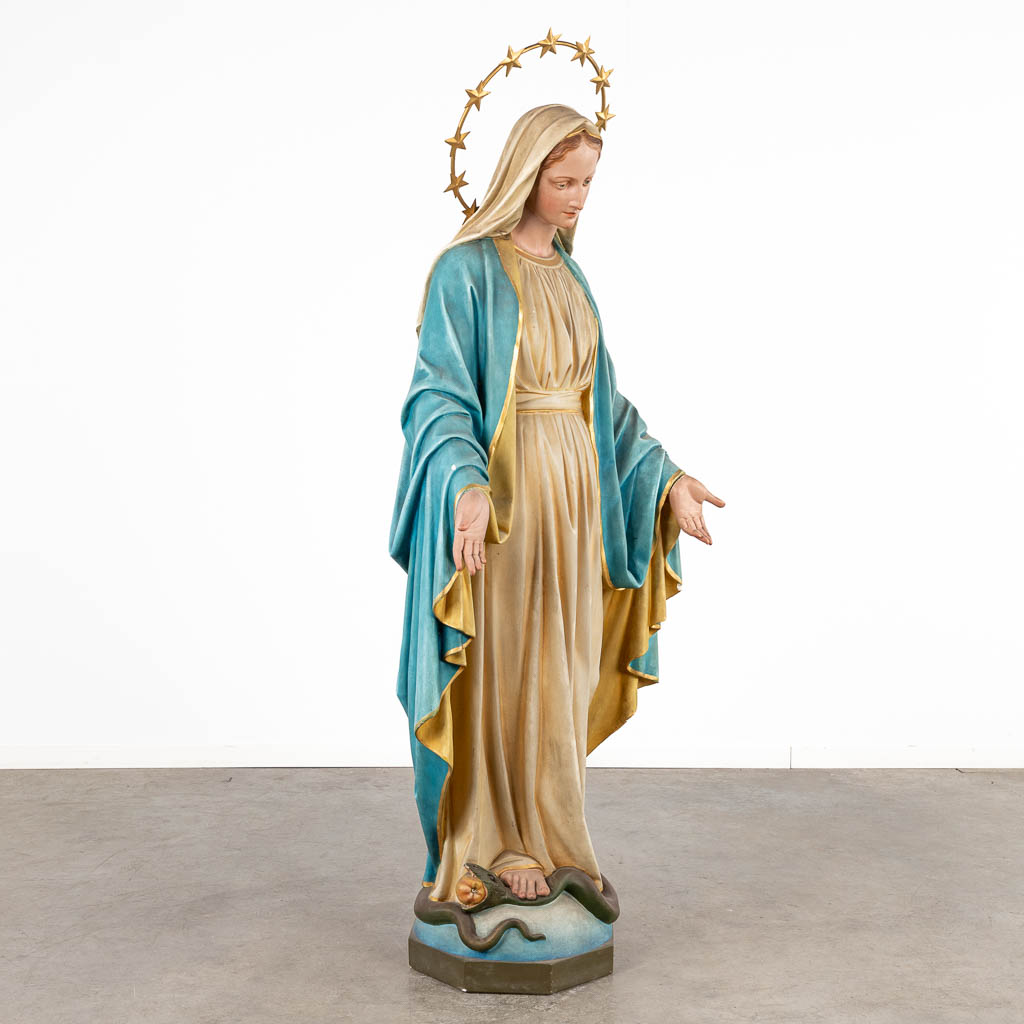 A lifesize figurine of Madonna trampling the Serpent, patinated plaster. Circa 1900. (D:43 x W:72 x H:183 cm)