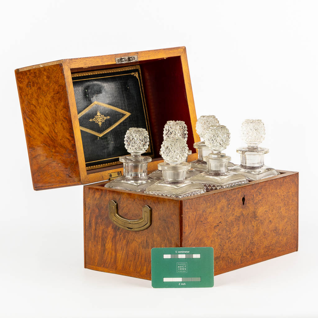 A six-bottle liquor box, root wood veneer and crystal. Circa 1900. (L:18 x W:28 x H:22 cm)