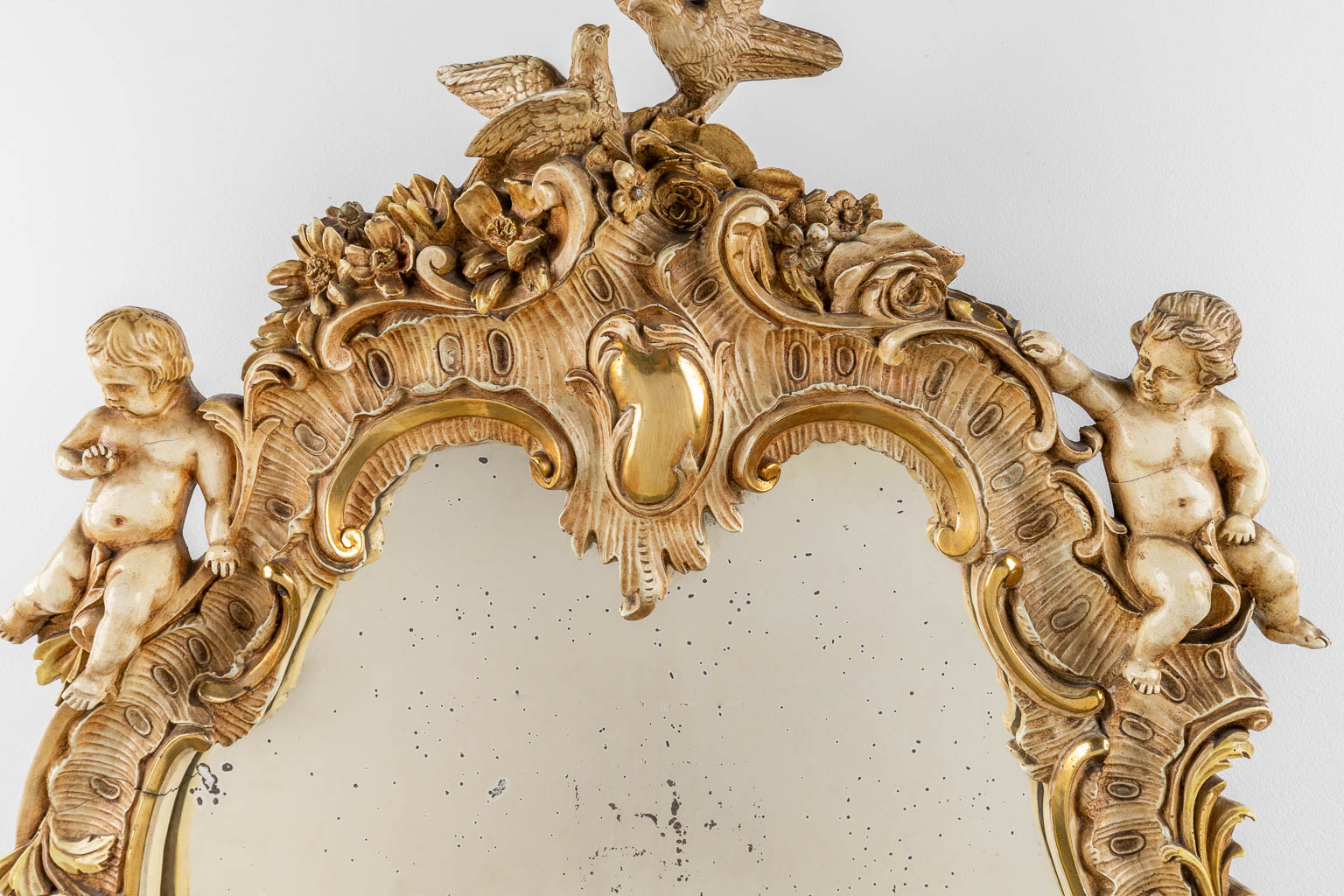 An antique mirror with musical putti. 1886. (W: 60 x H: 97 cm)