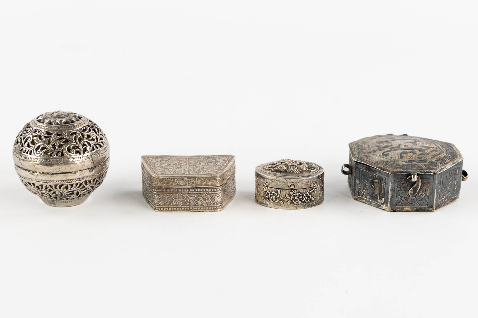 Fourteen Islamic and Indian Amulet or Trinklet boxes, Silver and silver-plate. 19th/20th C. (L:9,5 x W:16,5 x H:2,5 cm)